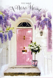 A tranquil doorway scene in Orpington evokes the quietly thrilling moment of stepping into a new home for the first time. The focal point is a pale pink door, its surface softly painted so the colour appears almost chalky and velvety under the natural light. Above, wisteria drapes in generous, trailing clusters of lavender and mauve, forming a floral frame that seems to sway gently, as if stirred by a light breeze flowing in from nearby parks like High Elms. The whitewashed walls surrounding the door bounce the sunlight back onto the façade, creating a clean, serene backdrop that enhances every pastel detail. To one side, a matching painted shutter in a muted rose tone ties the entrance together, adding an extra touch of charm. Resting on the doorstep is a metal bucket in a soft grey, filled to overflowing with plush white and cream roses. Their petals, densely layered and slightly ruffled at the edges, give the arrangement a luxurious yet approachable feel, the kind you might expect from a skilled local florist. Wisps of green foliage thread through the blooms, lending natural movement and freshness. A satin ribbon in gentle pink is fastened around the bucket, its tails falling lightly and catching the light. The overall mood is hopeful and intimate, as if this arrangement has just been delivered to mark a move into a cosy house off Sevenoaks Road-a floral gesture that whispers congratulations, fills the threshold with scent and colour, and turns an ordinary step into a symbol of welcome and new beginnings.